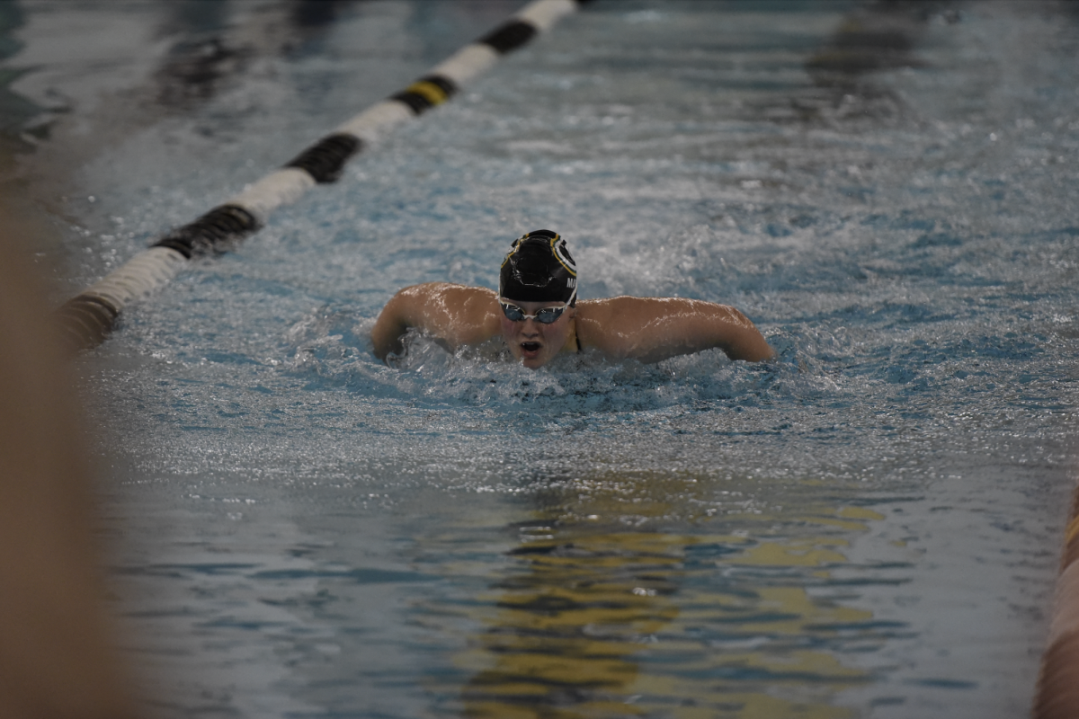 Bringing her arms forward in sync, senior Lily Matya swims the 200 Yard Individual Medley on Dec. 5. 